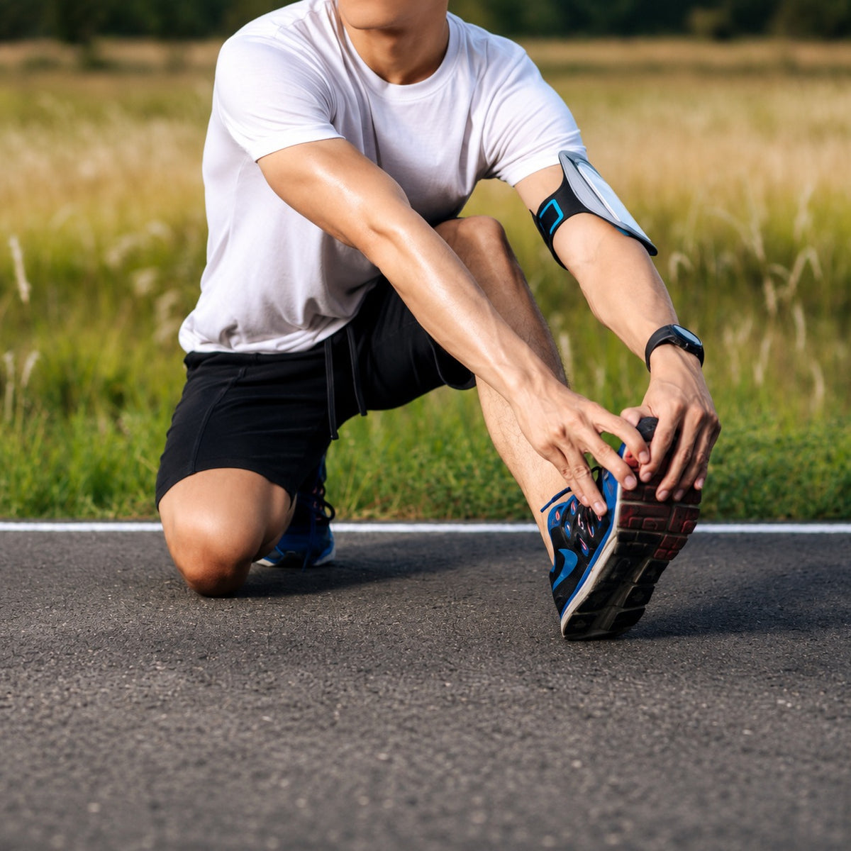 Male runner stretching legs on road wearing blue athletic running shoes
